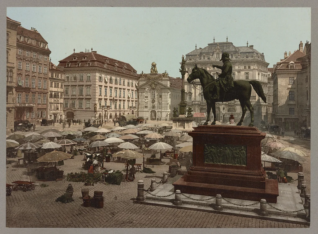Am Hof, Wien, mit Freiluftmarkt und Reiterstandbild im Vordergrund, ca. 1890